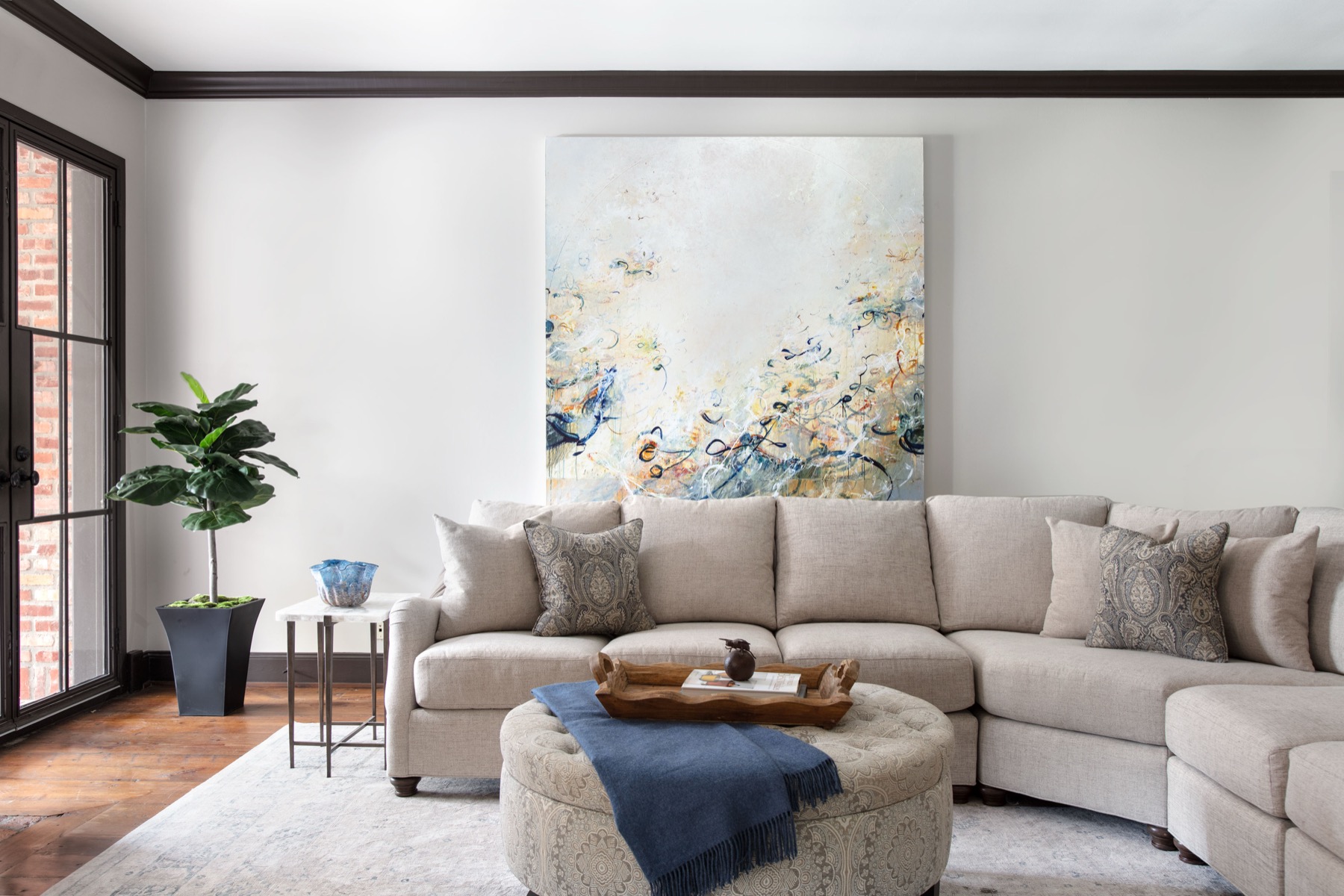 A Pamela Hope Designs living room with a large abstract artwork above the sofa