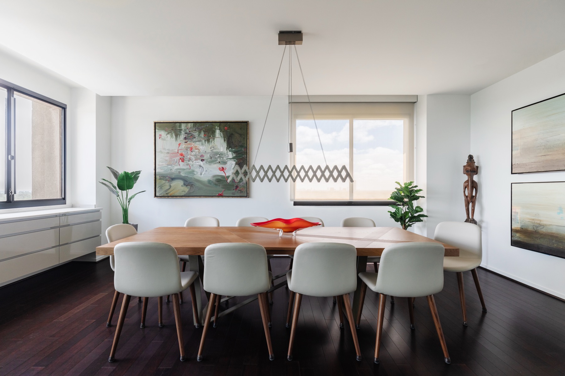 A Houston high-rise dining room with paintings and sculpture
